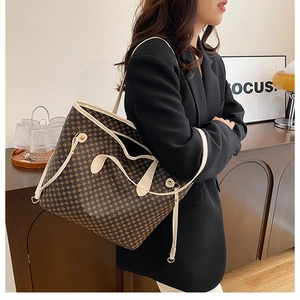 Detail of vintage tote bag with geometric pattern being carried by a model on shoulder