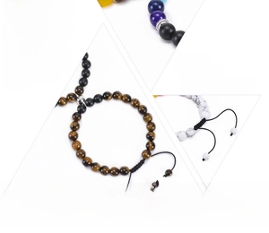 Detail of natural tiger eye and chakra beads on woven and elastic yoga bracelets