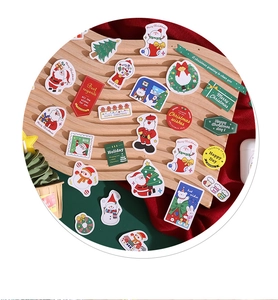 Detailed view of Christmas stickers featuring Santa and trees on a wooden tray
