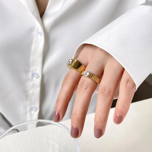 Close-up of elegant gold gear-designed couple rings with sparkling one-carat diamonds