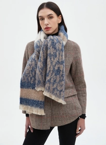 Detail view of beige and blue leopard print scarf with soft texture and fringe edges