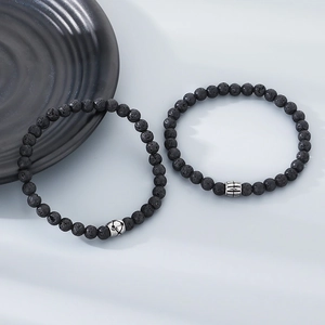 Close-up of black lava stone bracelets with vintage silver textured titanium steel beads