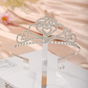 Detail of silver rhinestone graduation crown featuring GRAD lettering for ceremonies