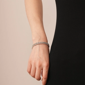 Close-up of double-layer silver bangle with micro-pave crystals on female wrist