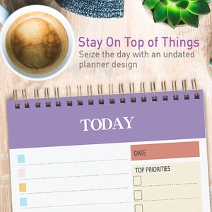 Flat lay of purple spiral planner with Today tasks on light wood background with latte