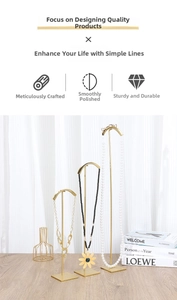 Three-piece set of gold metal jewelry stands in varying heights for necklace display