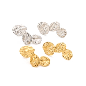 Textured irregular gold and silver oval drop earrings with hammered metal design