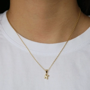 Polished 18k gold balloon letter K pendant necklace on a minimalist link chain