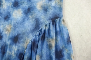 Detailed macro view of tie-dye mesh fabric with ruffled seams and pleated texture