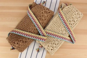 Detail of bohemian hollow paper rope woven beach bags with colorful geometric straps