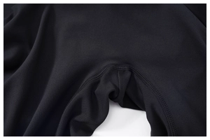 Macro view of high-elastic black yoga jumpsuit featuring reinforced four-needle six-thread seams