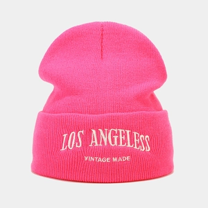 Detail of bright pink knitted beanie with white Los Angeles vintage embroidery