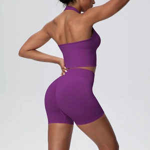 Side view of purple seamless yoga set showing ribbed high waist shorts and halter top