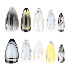 Handmade Y2K almond press on nails with yellow ink smudge and silver foil accents