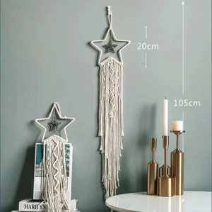 Detailed view of hand-woven cotton star macrame wall hanging with long tassels and fringes
