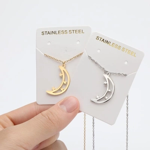 Minimalist gold and silver stainless steel star and moon pendant necklaces on card