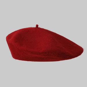 Close-up of dark red wool beret showing premium felt texture and minimalist design