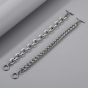 Detail view of silver stainless steel O-chains with OT buckle closure on grey background
