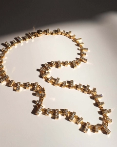 Detail of Y-shaped gold necklace with zircon rectangles and a magnetic clasp