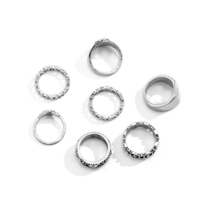 Detail shot of a 7-piece silver alloy ring set featuring vintage embossed patterns