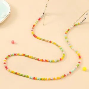 Detail of colorful beaded eyewear chain with gold lobster clasps and clear rubber loops