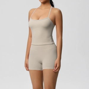 Detail of high-stretch beige yoga set featuring a slim camisole and high-waisted gym shorts