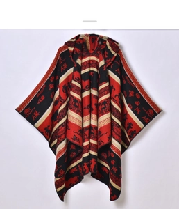 Close-up of thick jacquard knit fabric on ethnic hooded poncho with red and black stripes