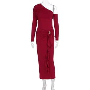 Detail of burgundy ruched maxi dress featuring a rhinestone brooch and slanted neckline