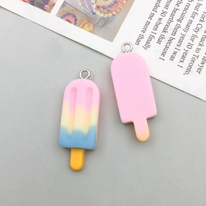 Close-up of resin ice cream pendants with vibrant gradient colors and metal rings