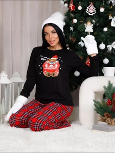 Detailed view of Christmas pajamas featuring a cartoon bear and red plaid festive trousers