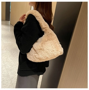 Close-up of soft beige plush hobo bag with furry texture on a model's shoulder