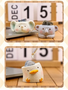 Detail of cartoon animal aroma stone diffusers on a cozy wooden desk with essential oil