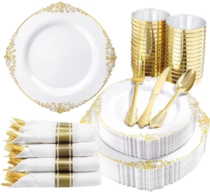 Detail shot of disposable gold-rimmed white plates, golden cutlery, cups and napkins set
