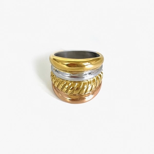 Modern multi-layer mixed metal ring with 18K gold and silver polished stacking bands