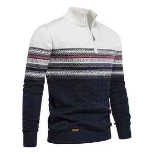 Close-up of three-tone patchwork knit sweater with navy cable texture and half-zip collar