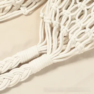 Detail of hollow woven cotton rope bag showing artisanal knots and sturdy handle craft