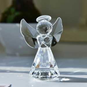 Macro detail of faceted crystal angel figurine showing light refraction and rainbow spots