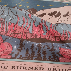 Close-up of Bohemian tarot tapestry showing fabric texture and mystical fire illustration