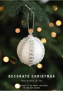 Detail of white frosted Christmas ball with silver rhinestones and glitter finish