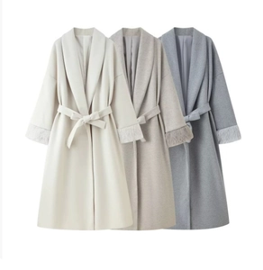 Detailed view of long wool coats with faux fur cuffs in cream, beige, and blue grey shades