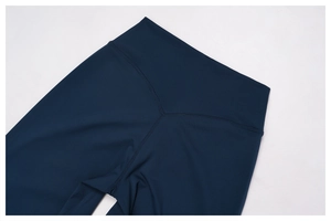 Detail of high-waisted navy blue yoga pants showing the V-shape back yoke stitching