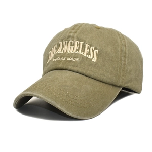 Macro detail of Los Angeles vintage embroidery on washed olive cotton baseball cap