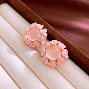 Macro view of pink flower stud earrings with resin center and delicate rose petals
