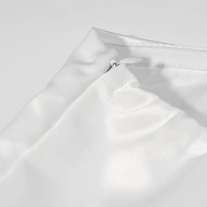 Detail of invisible side zipper on elegant white satin long dress for a seamless finish