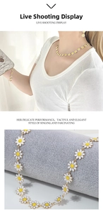 Detail of floral daisy jewelry set featuring white petals and golden finish on a display
