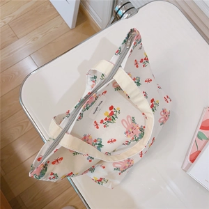 Detail of cute rabbit print cotton tote bag with soft inner lining and brand label