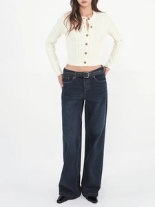 Detailed cable knit pattern on white cropped cardigan with amber buttons for women