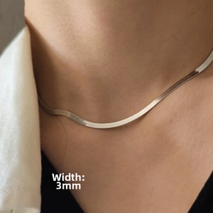 Detail of 3mm wide titanium steel flat snake chain necklace showing polished metal texture