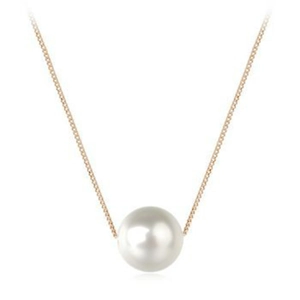 Detail of a round white pearl pendant on a polished gold chain against a white background