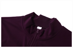 Detailed macro view of the stand collar and matching half-zipper on deep purple yoga jacket